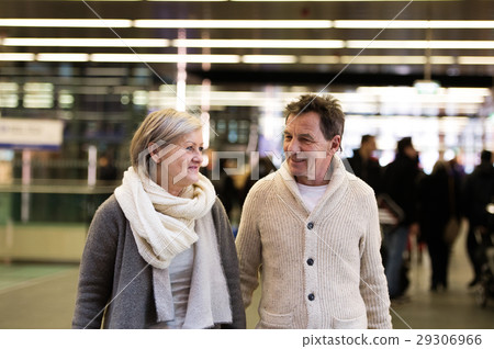 Senior couple walking in hallway of subway 29306966