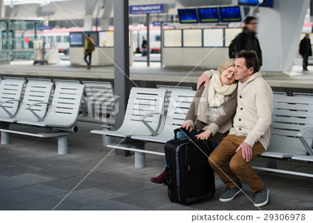 Senior couple waiting on train station, sitting on Senior couple waiting on train station, sitting on 29306978