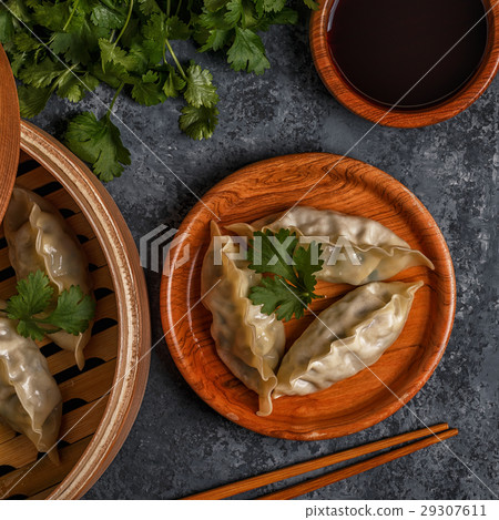Fresh dumplings on a dark stone background. Fresh dumplings on a dark stone background. 29307611