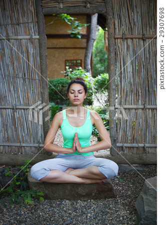 Young woman doing yoga asana in the evening Young woman doing yoga asana in the evening 29307698