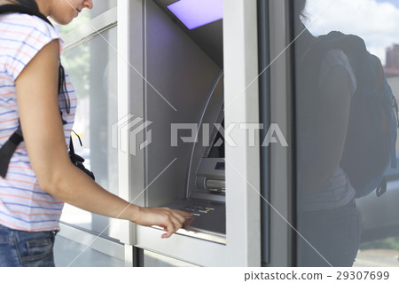 Woman using banking machine. 29307699