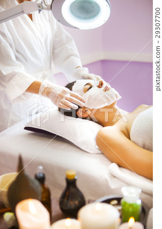 Beautiful woman getting a facial treatment at spa Beautiful woman getting a facial treatment at spa 29307700