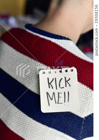 man with a note with the text kick me 29308156