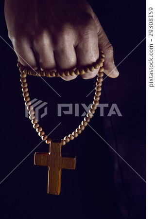 young man with a rosary in his hand young man with a rosary in his hand 29308159