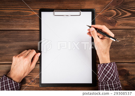 Clipboard on a wooden table Clipboard on a wooden table 29308537