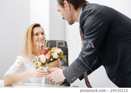 Pleasant employer presenting gift to the employee Pleasant employer presenting gift to the employee 29310123