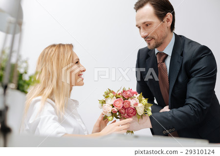 Cheerful businessman presenting gift to the Cheerful businessman presenting gift to the 29310124