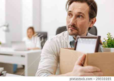 Frightened fired employee holding the box in the Frightened fired employee holding the box in the 29310165