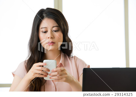 Beautiful young Asian woman using smart phone Beautiful young Asian woman using smart phone 29314325