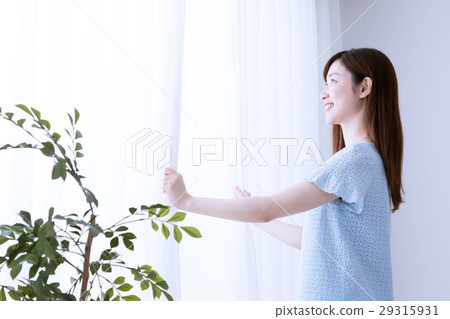 Woman opening curtain, early morning, sunlight Woman opening curtain, early morning, sunlight 29315931