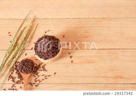 raw rice in bowl with  dried rice plant on wooden 29317342