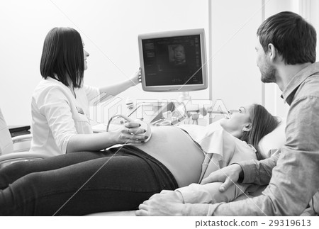 Monochrome shot of a loving pregnant couple at the Monochrome shot of a loving pregnant couple at the 29319613