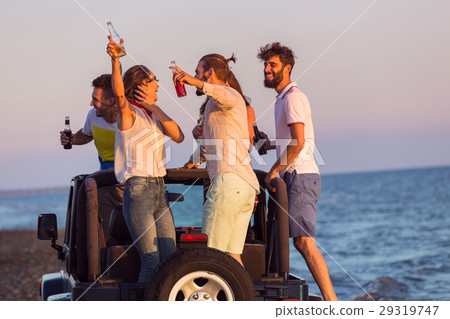 young group having fun on the beach and dancing in 29319747