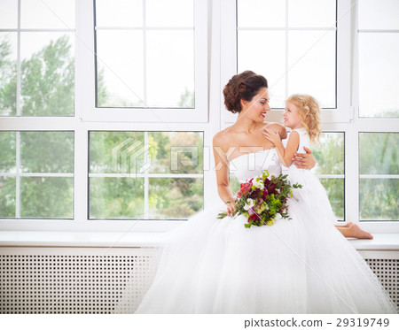 Smiling happy bride and a flower indoors Smiling happy bride and a flower indoors 29319749