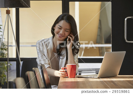 The young lady with her smartphone in the office The young lady with her smartphone in the office 29319861