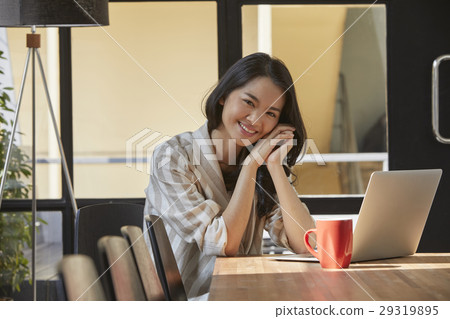 The woman looks very happy in the morming in the office 29319895