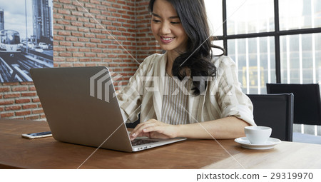 Portrait of beautiful woman working on laptop in office. Portrait of beautiful woman working on laptop in office. 29319970