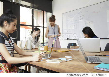 Young colleagues are discussing new business ideas in office. Young colleagues are discussing new business ideas in office. 29320063