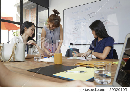 a group of people is working together on a project 29320105