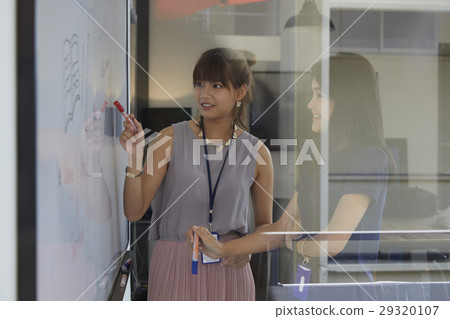 business women are discussing new plan in office. 29320107