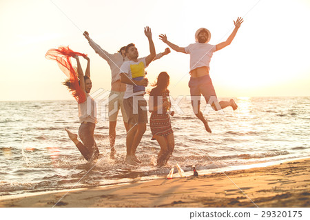 group of happy young people dancing at the beach group of happy young people dancing at the beach 29320175