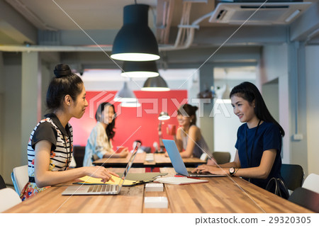 A group of office ladies working in a modern workplace A group of office ladies working in a modern workplace 29320305