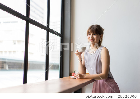 A young businesswoman is drinking coffee in the morning A young businesswoman is drinking coffee in the morning 29320306