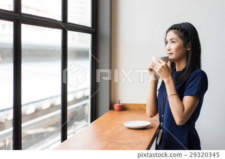 the businesswoman is drinking coffee the businesswoman is drinking coffee 29320345