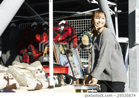 A woman enjoying a flea market 29320874