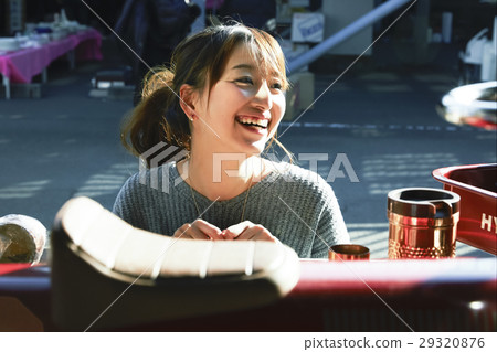 A woman enjoying a flea market 29320876