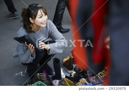 A woman enjoying a flea market A woman enjoying a flea market 29320970