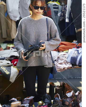 A woman enjoying a flea market A woman enjoying a flea market 29321173