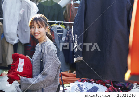 A woman enjoying a flea market 29321216