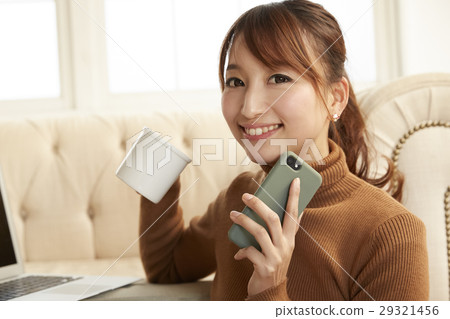 A woman watching a smartphone A woman watching a smartphone 29321456
