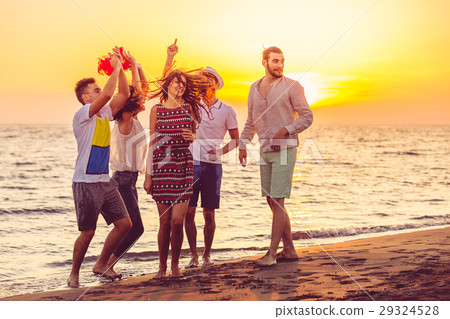 Young People Dancing On Beach at Sunset Young People Dancing On Beach at Sunset 29324528