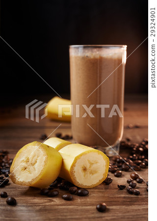 Coffee and banana smoothie in a glass on a wooden  Coffee and banana smoothie in a glass on a wooden  29324901