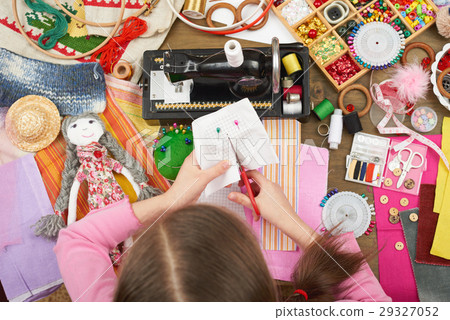 girl sews doll clothes top view sewing accessories 29327052