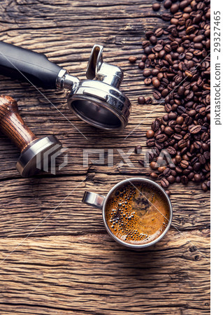 Black coffee with coffee beans and portafilter. 29327465