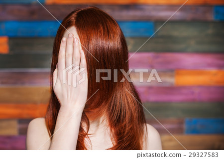 faceless girl covers her face with his hand 29327583