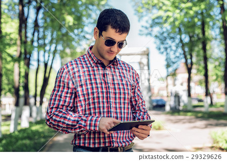 The man in the summer in the park, reading glasses The man in the summer in the park, reading glasses 29329626