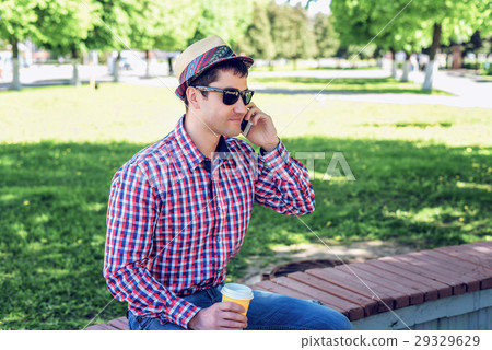 man in  shirt and jeans  glasses, talking on t 29329629