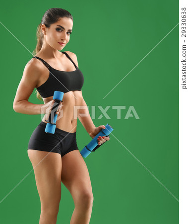 Young attractive woman with dumbbells in her hands Young attractive woman with dumbbells in her hands 29330638