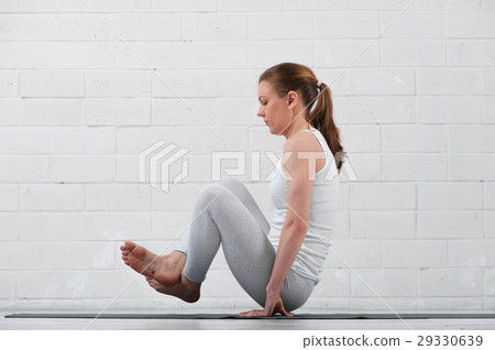 Flexible woman practicing high level yoga indoors Flexible woman practicing high level yoga indoors 29330639