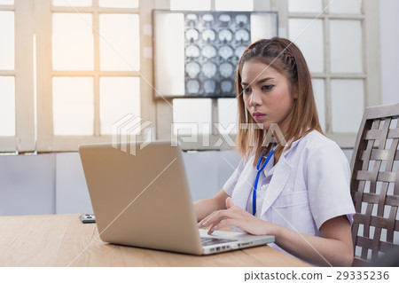 Confident female doctor sitting at office desk, health care and 29335236