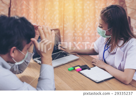 doctor talking to her male patient at hospital doctor talking to her male patient at hospital 29335237