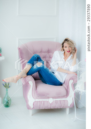 Pretty blonde woman posing on pink armchair 29337890