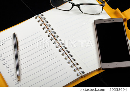 Top view of an open note book, glasses, pen and 29338694