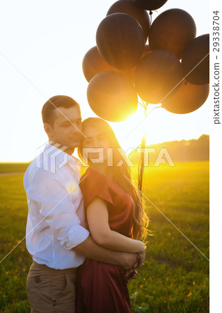 young couple hugging at sunset 29338704