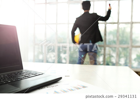 Architect man standing with laptop in foreground Architect man standing with laptop in foreground 29341131