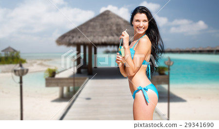 happy woman with bottle of drink on summer beach 29341690